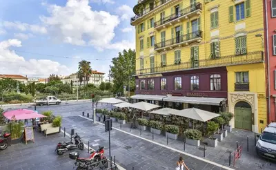 a hallway with a sliding glass door with a table at Appartement coeur du vieux Nice in Nice