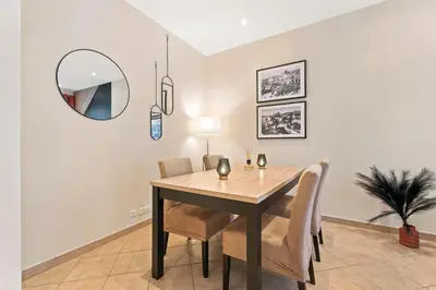 a dining room with a table and chairs and a mirror at Nice - Renting - LASCARIS - Charm & Spacious & Comfort 3P Port Bonaparte in Nice