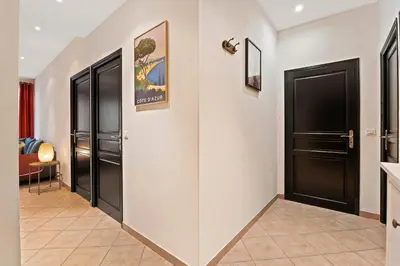 a hallway with black doors and a tile floor at Nice - Renting - LASCARIS - Charm & Spacious & Comfort 3P Port Bonaparte in Nice