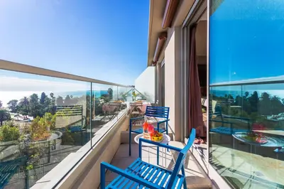 two blue chairs on a balcony with a view at PLAZA TERRACE AP4065 by RIVIERA HOLIDAY HOMES in Nice