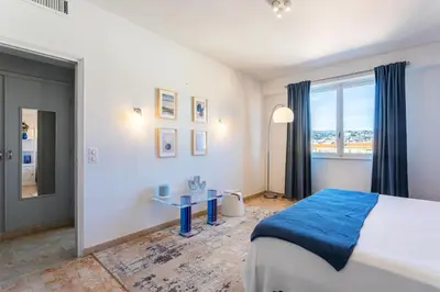 a bedroom with a bed and a desk and a window at PLAZA TERRACE AP4065 by RIVIERA HOLIDAY HOMES in Nice