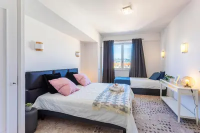 a bedroom with two beds and a window at PLAZA TERRACE AP4065 by RIVIERA HOLIDAY HOMES in Nice