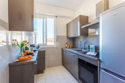 a kitchen with stainless steel appliances and a window at PLAZA TERRACE AP4065 by RIVIERA HOLIDAY HOMES in Nice