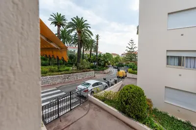 a view of a street from a balcony of a building at Magnifique Studio à Beaulieu-sur-mer in Beaulieu-sur-Mer