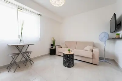 a living room with a couch and a table at Magnifique Studio à Beaulieu-sur-mer in Beaulieu-sur-Mer