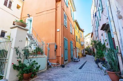 an alley in an old town with buildings at VOLTI ON THE BAY AP4386 By Riviera Holiday Homes in Villefranche-sur-Mer