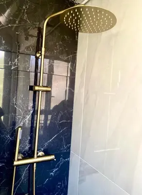 a shower with a shower head in a bathroom at Charming studio overlooking a beautiful garden in Nice