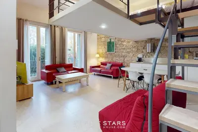 a living room with a red couch and a table at Loft Gambetta 33 Fshh in Nice