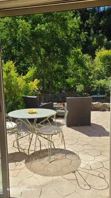 a table and chairs sitting on a patio at La Laghetanne, idéalement située entre Nice et Monaco Maison Indépendante Voiture indispensable in La Trinité