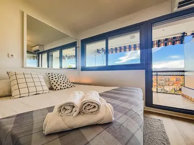 a bedroom with a large bed with towels on it at Le Baccarat - Wifi, AC, vue mer, 4 pers in Nice