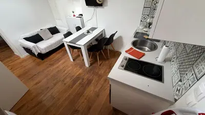 a kitchen and a living room with a table at Appartement T2 coconing, WIFI, INTERNET, CLIM, 300m plage in Nice