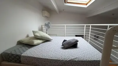 a bedroom with a bed with two pillows on it at Appartement T2 coconing, WIFI, INTERNET, CLIM, 300m plage in Nice