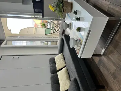 a table with two wine glasses and a bag on a balcony at Studio centre ville de Nice à 200m de la plage in Nice
