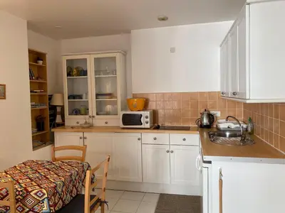 a kitchen with white cabinets and a sink and a microwave at Centre ville in Nice