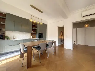 a kitchen and dining room with a wooden table and chairs at Nestor&Jeeves - BELLE EPOQUE - Central, Close sea in Nice