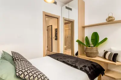 a bedroom with a bed and a plant on a shelf at Nestor&Jeeves - ADRIANA - Central, Close sea in Nice