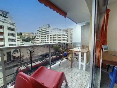 a balcony with a table and chairs and a view of a city at Nestor&Jeeves - FLORIDA BEACH - Studio with balcony in Nice