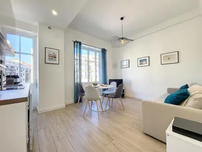 a living room with a couch and a table at Nestor&Jeeves - BLEU BUFFA - Central location in Nice