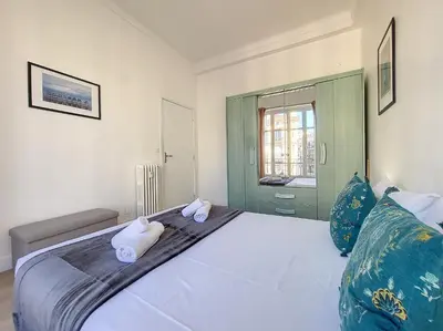a bedroom with a large white bed with two pillows at Nestor&Jeeves - BLEU BUFFA - Central location in Nice