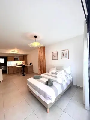 a bedroom with a large bed in a room at Appartement neuf coup de coeur entre Èze et Monaco in Èze