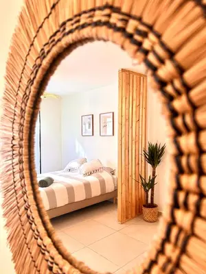 a bedroom with a bed and a mirror at Appartement neuf coup de coeur entre Èze et Monaco in Èze