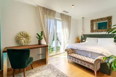 a bedroom with a bed and a desk and a window at Luxury Villa Nice in Nice