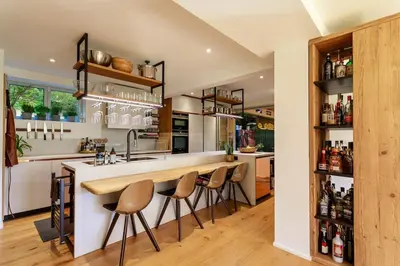 a kitchen with a bar with stools around it at Luxury Villa Nice in Nice