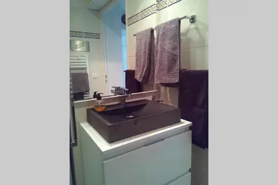 a bathroom with a black sink and a mirror at Villa Tobias in Nice