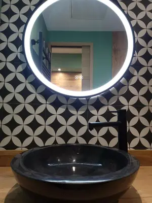 a bathroom with a black sink and a mirror at Cosy Haven 5 min from Nice Carnival Hyper-Center! in Nice