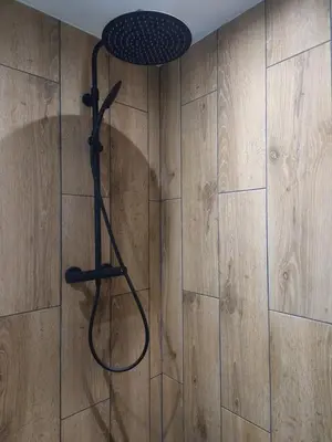 a shower in a bathroom with a shower head at Cosy Haven 5 min from Nice Carnival Hyper-Center! in Nice