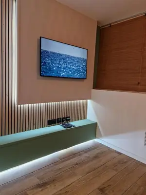 a room with a flat screen tv on the wall at Cosy Haven 5 min from Nice Carnival Hyper-Center! in Nice