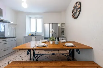 a kitchen with a wooden table with plates on it at Cozy 1 Bdr at Nice Port in Nice