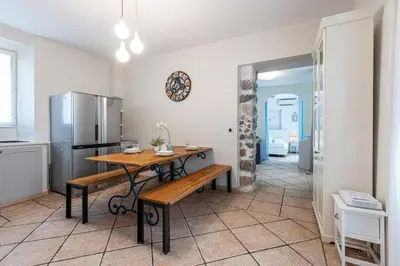 a kitchen with a table and a refrigerator at Cozy 1 Bdr at Nice Port in Nice