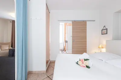 a bedroom with a white bed with a flower on it at Cozy 1 Bdr at Nice Port in Nice