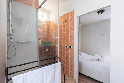 a small bathroom with a shower and a bed at Cozy 1 Bdr at Nice Port in Nice