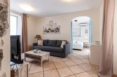 a living room with a couch and a table at Cozy 1 Bdr at Nice Port in Nice