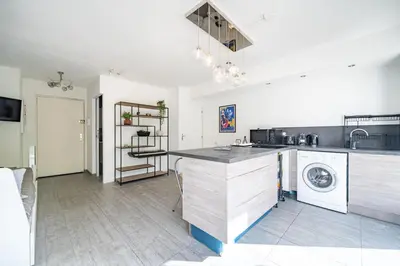 a kitchen with a sink and a washing machine at Le calme à Nissa la Bella in Nice