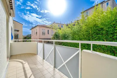 a balcony with white doors and a fence at Le calme à Nissa la Bella in Nice