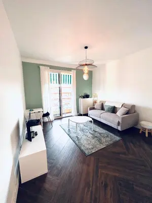 a living room with a couch and a table at Happy Home spacieux studio en dernier étage avec balcon à 5 minutes à pieds du vieux Nice et de la mer Quartier Dubouchage in Nice