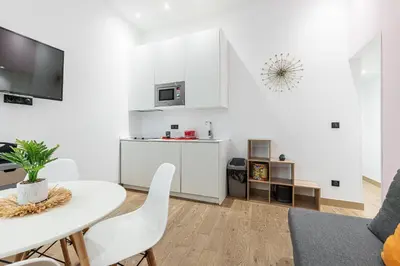 a white living room with a white table and chairs at Garibaldi Square - Cozy 1 Bdr Old Town in Nice