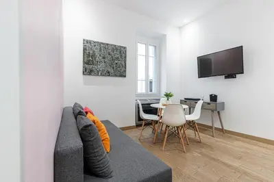 a living room with a couch and a table at Garibaldi Square - Cozy 1 Bdr Old Town in Nice