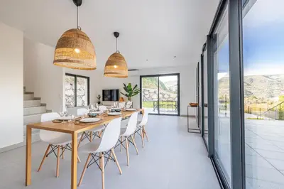 a kitchen with white counters and white stools at Villa Riviera - Nouveaute entre mer et montagnes in Colomars