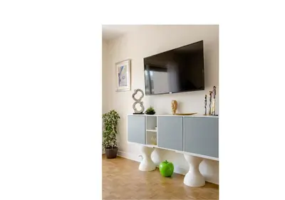 a living room with a tv and a white cabinet at 2Bed 2Bath Sea View Promenade Bright & Spacious! BRAVOSTAYSRIVERIA in Nice