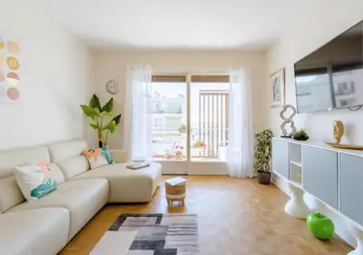 a living room with a white couch and a large window at 2Bed 2Bath Sea View Promenade Bright & Spacious! BRAVOSTAYSRIVERIA in Nice