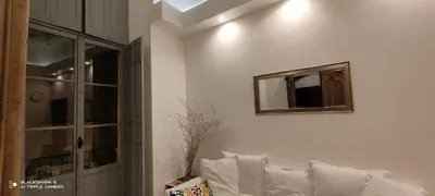 a living room with a mirror and a white couch at Downtown in Nice