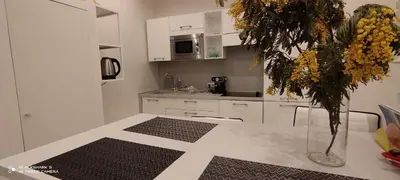 a kitchen with a table with a vase of flowers on it at Downtown in Nice