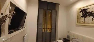 a living room with a tv and a cabinet at Downtown in Nice