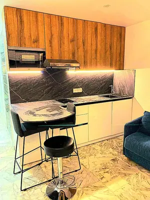 a kitchen with a table and a stool in a room at Côte d'Azur Oasis Suites in Nice
