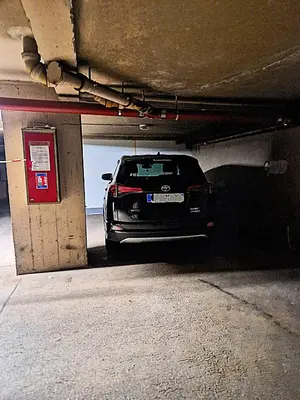 a car is parked in a parking garage at Côte d'Azur Oasis Suites in Nice