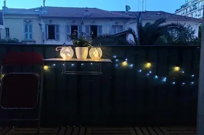 a table with lights on top of a fence at Spacieux 4 pièces de type bourgeois Art-déco in Nice